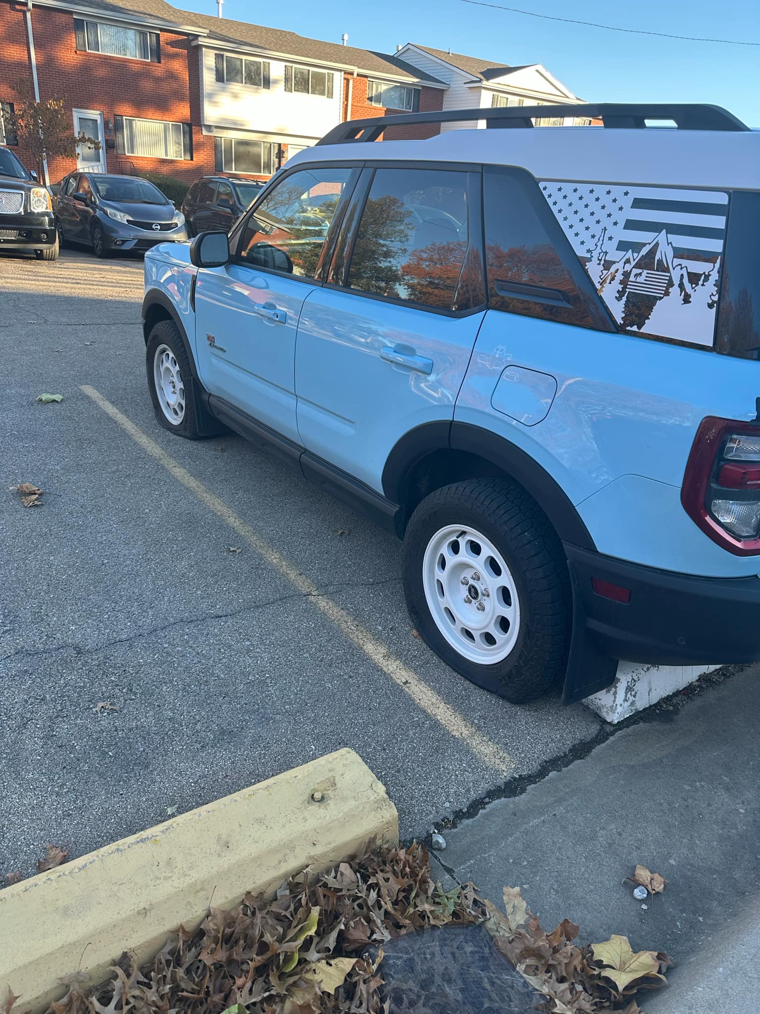 bronco - Tire Vandalism Spree Strikes Colonial Park Townhomes in Topeka, KS 1 Light blue Ford Bronco Sport with slashed tires parked in front of Colonial Park Townhomes in Topeka, KS