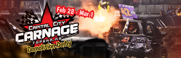 High-octane indoor demolition derby action at the 9th Annual Capital City Carnage in Topeka, featuring crashing cars and a cheering crowd.