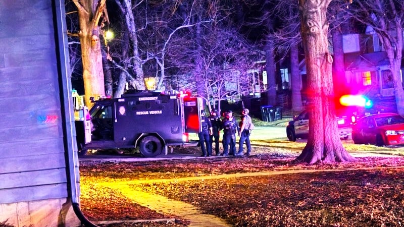 Police cars on a road at night in Central Topeka during standoff.