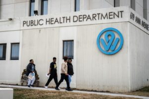 Zane Irwin / Kansas News Service People walk outside the Wyandotte County Public Health Department in Kansas City, Kansas.