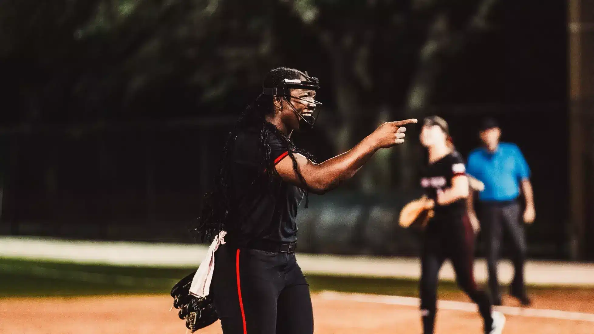 Nijaree Canady celebrating on the softball field, pointing and smiling with teammates in the background, photo by Texas Tech Athletics.