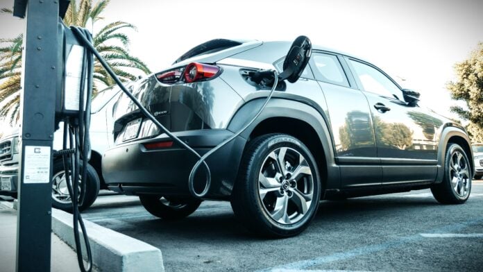 Gray Electric Car Parked on a Charging Bay By Kendel Media