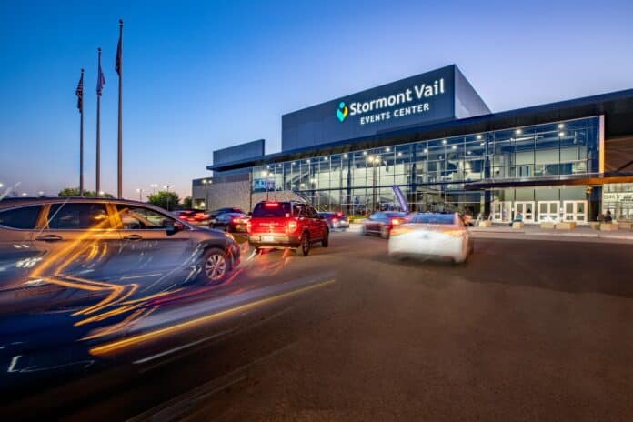 Stormont Vail Events Center entrance with cars driving by at sunset in Topeka, Kansas