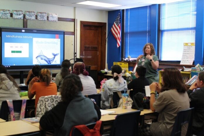 download (2) Susie Kelley, a fifth grade teacher at Harry Street Elementary School in Wichita, leads her class in a "Mindfulness Minute" breathing exercise. Educators say they are still seeing the effects of the COVID-19 pandemic on students, both academically and socially.