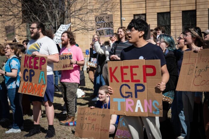 download (4) Students at the University of Kansas protested the removal of gender neutral spaces at a dormitory in February of this year.