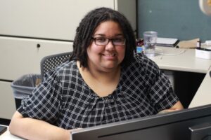 Whit Downing, vice president of policy and programming at the Kansas Council on Developmental Disabilities, works in her office. Before she found her calling as a disability rights advocate, she faced her own hardships getting access to crucial services.