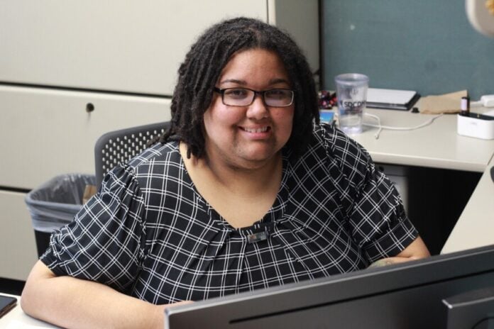 download (5) Whit Downing, vice president of policy and programming at the Kansas Council on Developmental Disabilities, works in her office. Before she found her calling as a disability rights advocate, she faced her own hardships getting access to crucial services.
