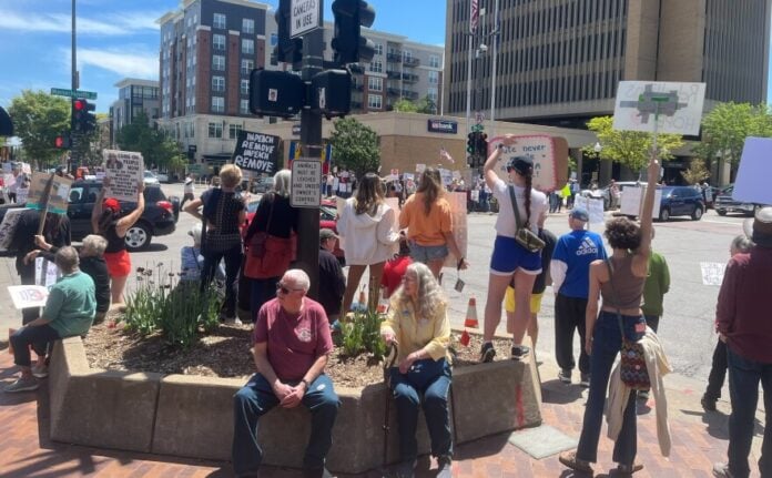 download (66) Protesters gather in downtown Lawrence to protest the Trump administration on Sunday, May 4. They gather each Sunday.