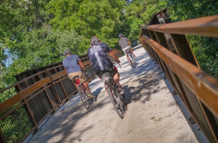 A group of cyclists rides the Flint Hills Trail.