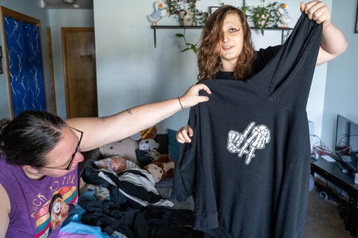 download (19) Janna Malcom helps her daughter Bri Johnson show off what she calls her "dysphoria hoodie," which she wears when she isn't feeling secure in her body.