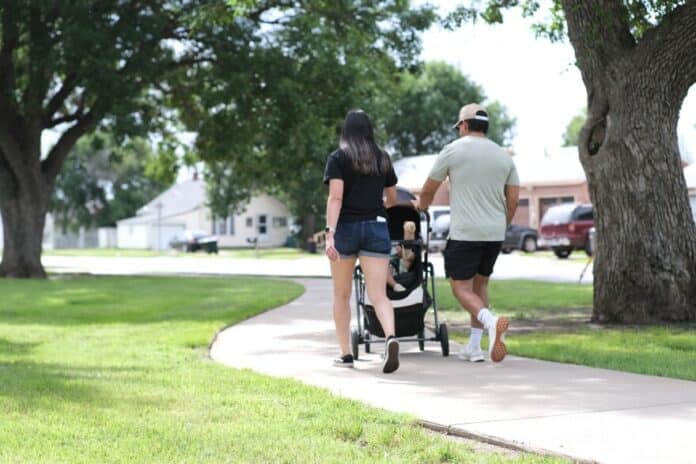 A young family walks down a path in Seward County.