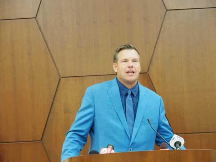 OLYMPUS DIGITAL CAMERA Attorney General Kris Kobach, shown speaking on the Washburn University campus, is battling the Kansas State Board of Education and Kansas Department of Education to remove from school district contracts tied to the U.S. Department of Agriculture food programs all references to Gov. Laura Kelly's policy prohibiting gender identity discrimination in contracting. (Tim Carpenter/Kansas Reflector)