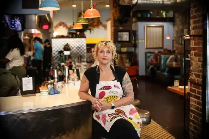 download (30) Meg Heriford, owner of Ladybird Diner in Lawrence, sits at the counter in her restaurant. She said she won't be able to afford health insurance this year if federal subsidies expire.