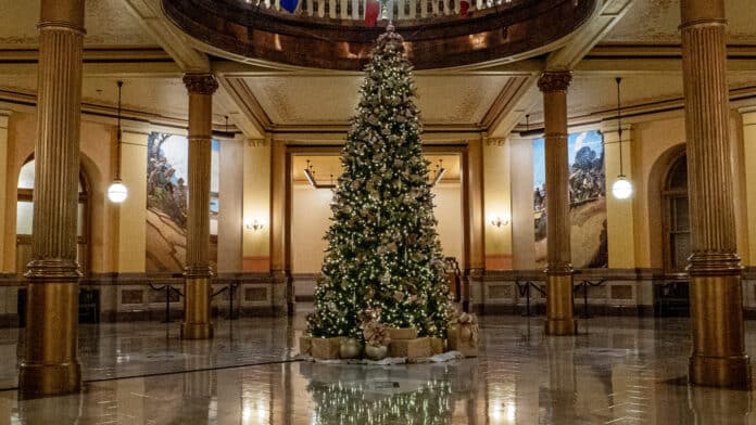 The Kansas Statehouse Christmas tree stands illuminated on Dec. 4, 2024. (Photo by Anna Kaminski/Kansas Reflector)