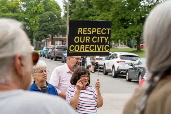 download (36) Zane Irwin / Kansas News Service Protesters cluster outside of the Leavenworth County District Court before a hearing between the city and CoreCivic.