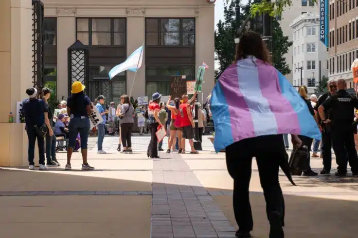 download (47) Bri Johnson, a transgender teen, approaches an anti-Trump rally in Wichita in June 2025. She asked to be homeschooled, in part out of fear that she couldn't use boys' or girls' restrooms at school without being harassed.