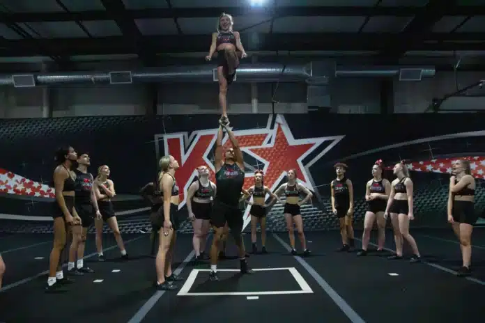 download (51) KC Cheer's Fierce Five team practices a stunt.