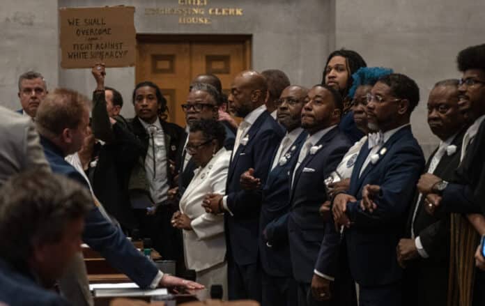 Tennessee Democrats lock arms on the Tennessee House floor in protest of a Republican redistricting vote that split up a majority-Black, majority-Democratic congressional district. Tennessee is one of several states redrawing its congressional maps in the aftermath of a recent US Supreme Court decision. (Photo by John Partipilo/Tennessee Lookout)
