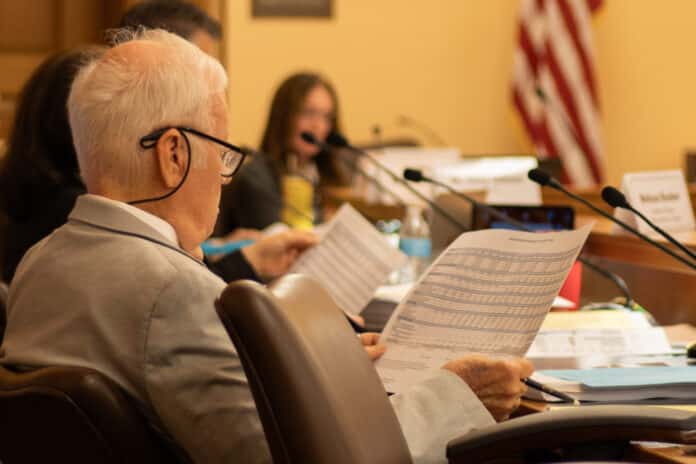 MG_0042-2048x1365 Jim Porter of the Kansas State Board of Education evaluates pages of data at an Education Funding Task Force meeting on May 27, 2026. (Photo by Baya Burgess/Kansas Reflector)