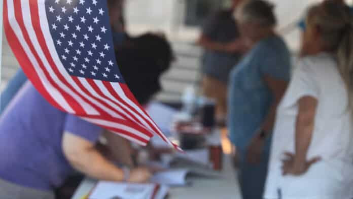 Organizers of a petition to put a proposed data center for Emporia to a public vote gather signatures on July 13, 2026, outside the cty offices. (Photo by Max McCoy/Kansas Reflector)