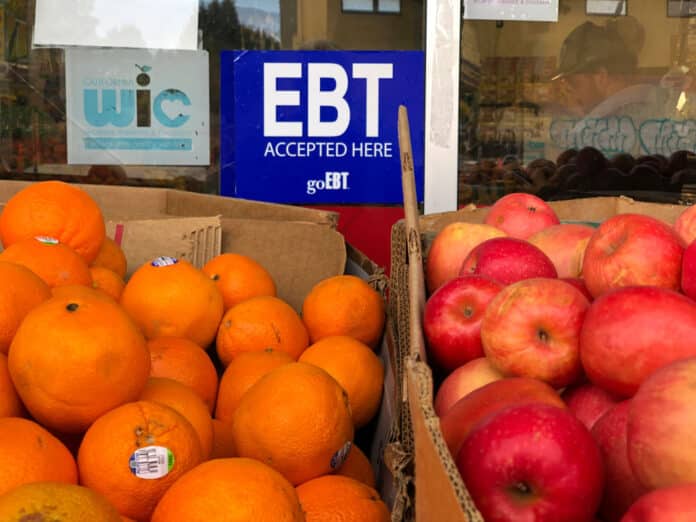 A sign noting the acceptance of electronic benefit transfer cards for food aid is displayed at a grocery store in California. New data shows millions of Americans have lost food stamps since the passage of a major law last year A sign noting the acceptance of electronic benefit transfer cards for food aid is displayed at a grocery store in California. New data shows millions of Americans have lost food stamps since the passage of a major law last year